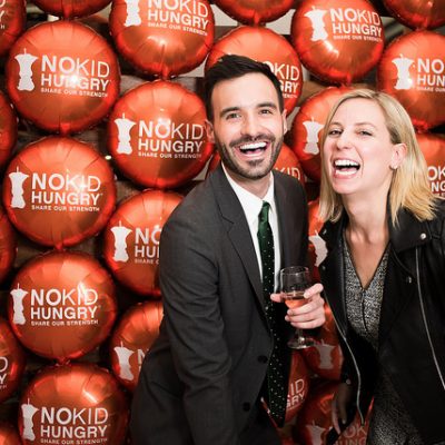 Man and Woman laughin holding glasses of wine