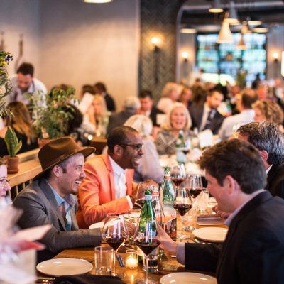 People laughing at dinner table venue