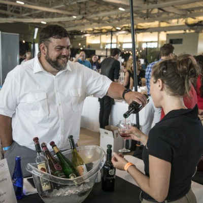 Man serving wine to guest